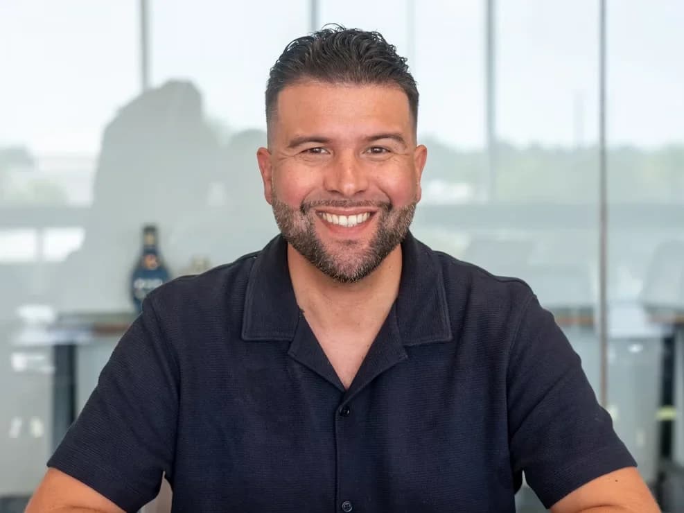 Someone smiling at a desk in an office